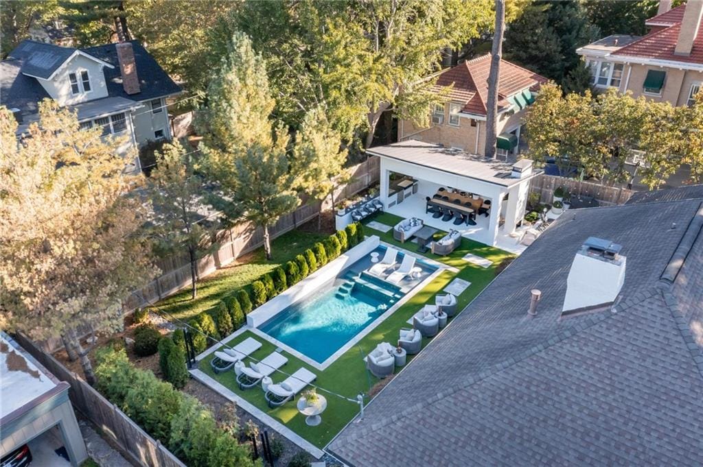 Aerial view of a finished backyard with a pool, patio, and pergola