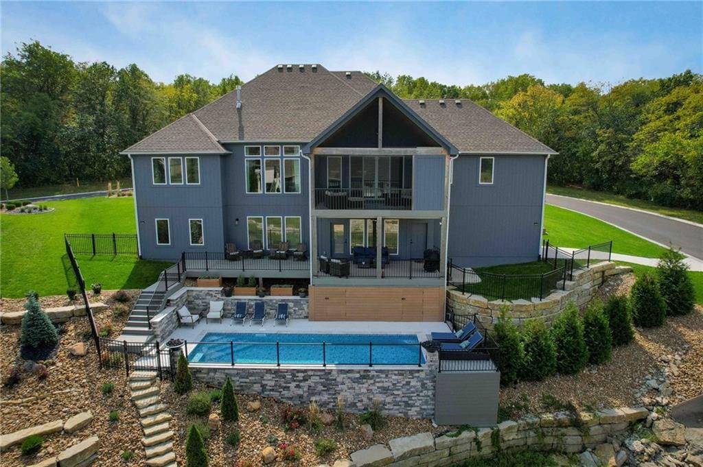 Two-story home with a rectangular swimming pool in the backyard