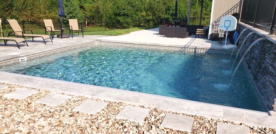 Rectangular pool with a raised spa and a water feature