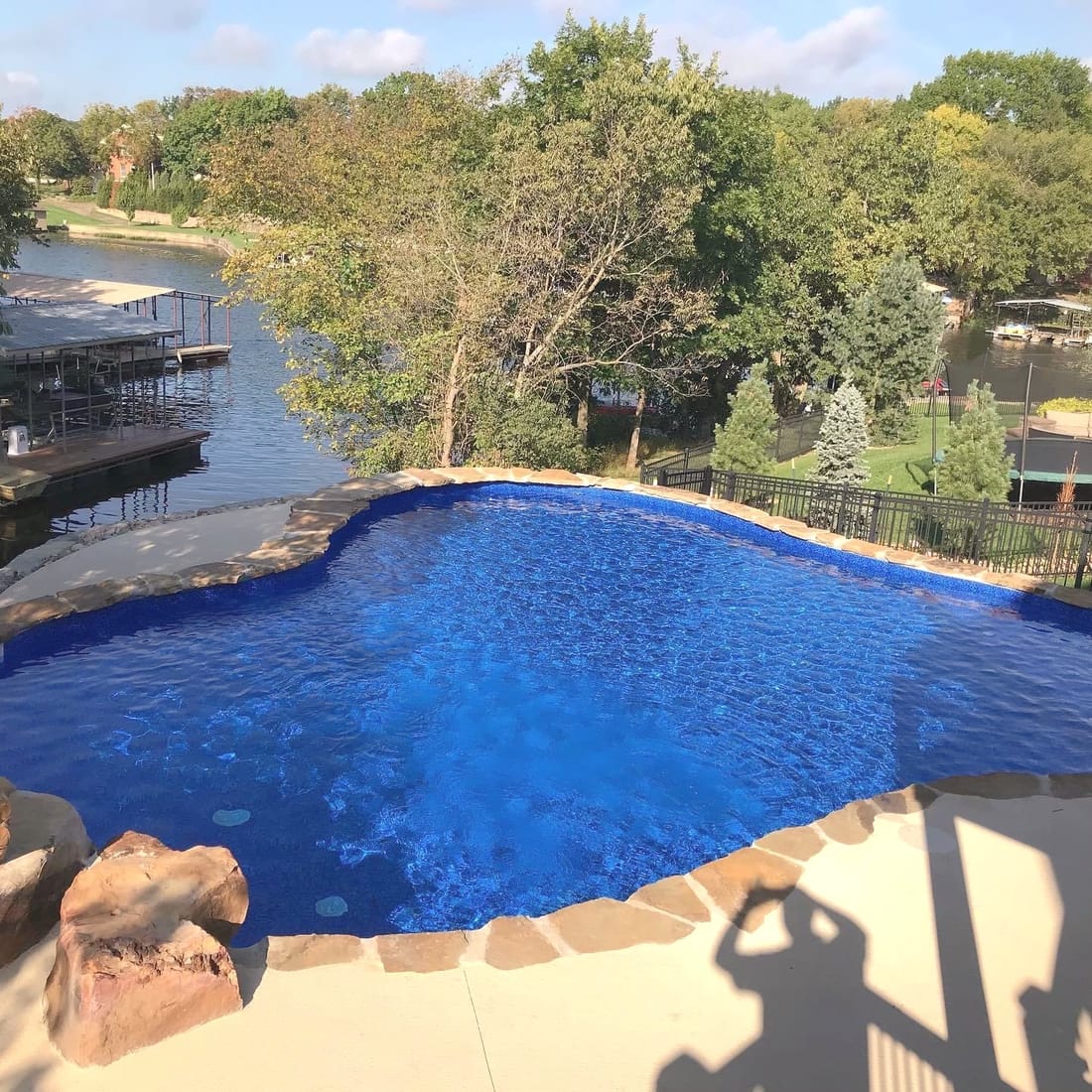 Geometric dark-bottom pool with a spa and fire feature